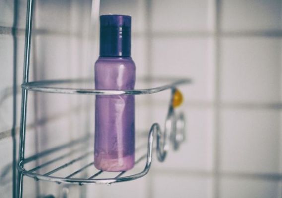 apkarpytas dušo kabinos su šampūno buteliuku vaizdas